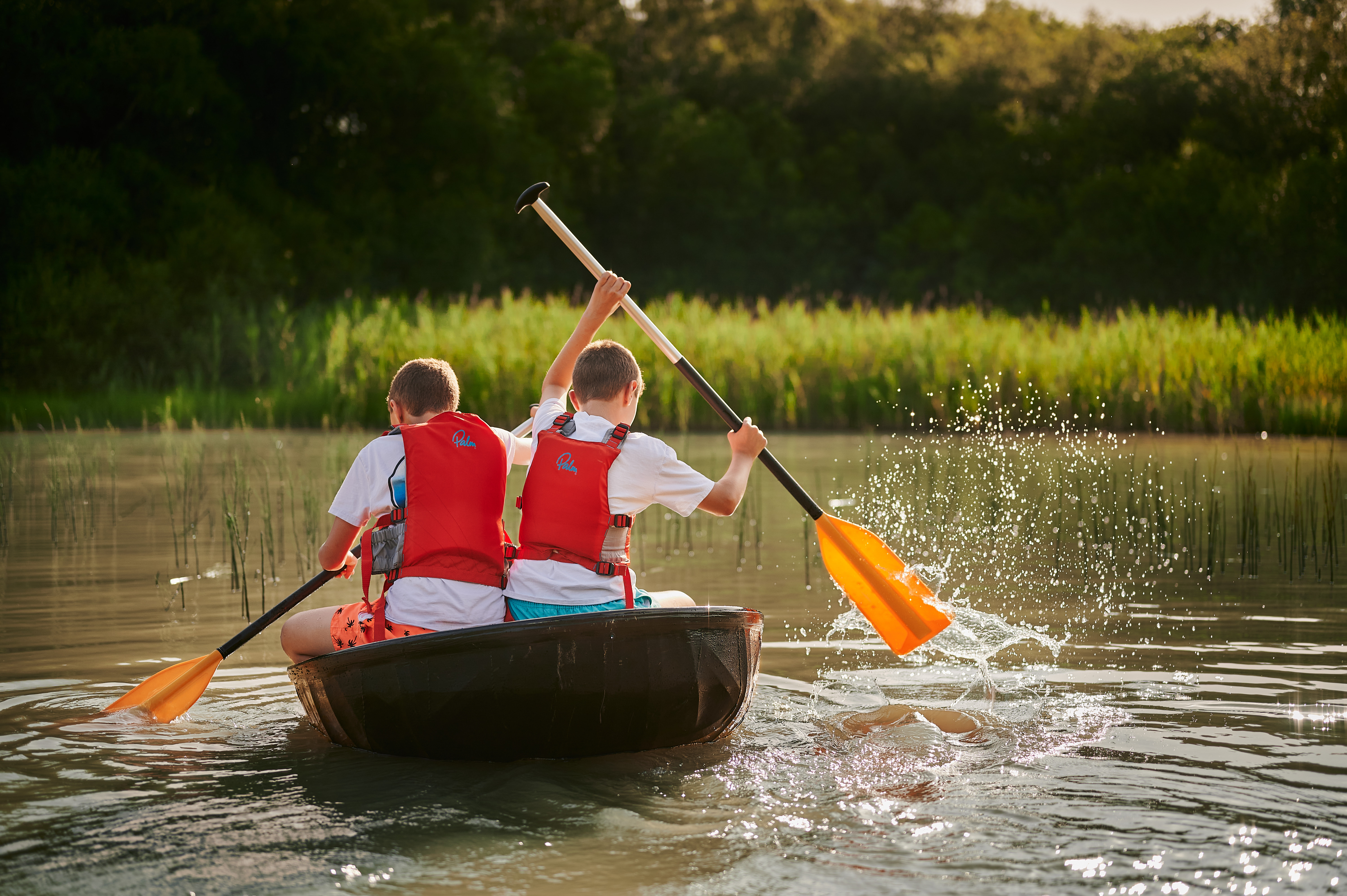 Two children in a round boat on a Coracle Safari