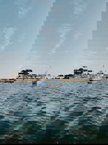 A boat on the water by Sandbanks beach