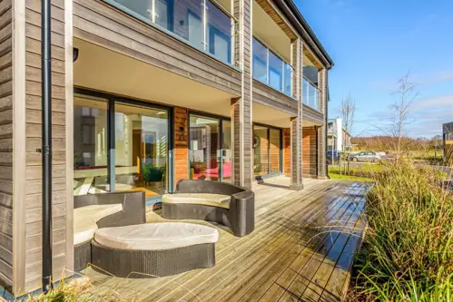 The outside patio area of a lakeside lodge